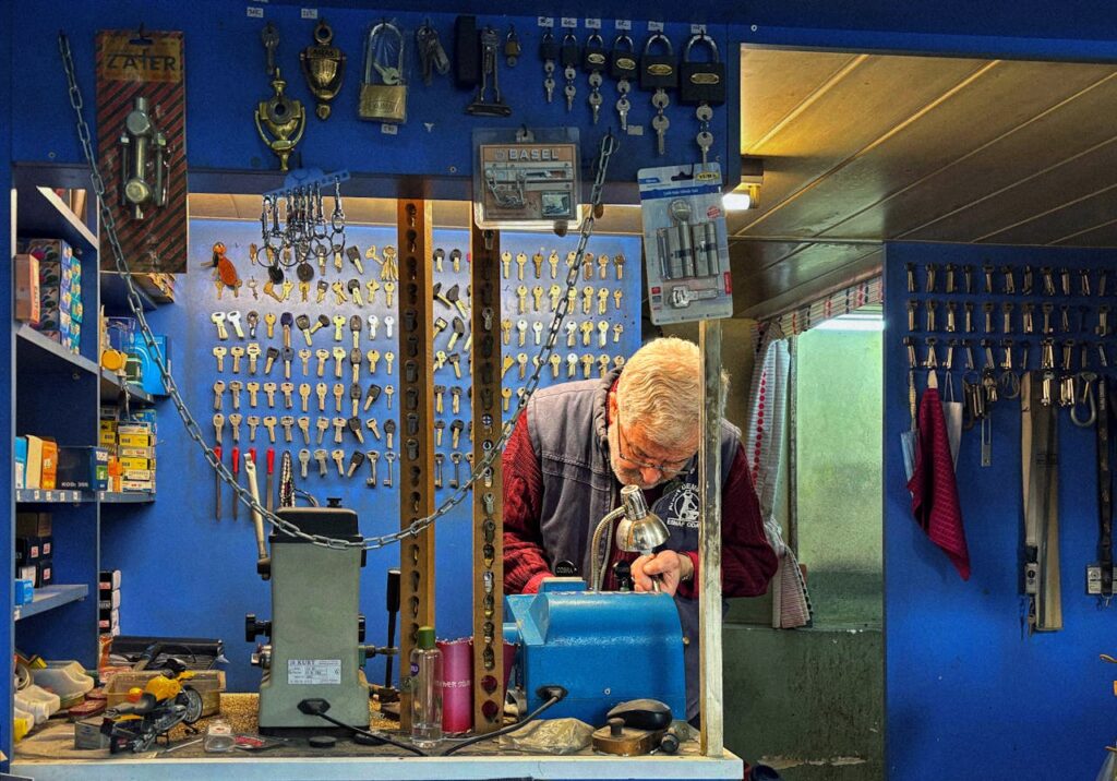 An elderly locksmith, possibly in the Middle-East